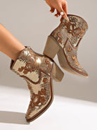 Moncelia gold sequin western ankle boots, held by model showing stacked block heel, women's sizes 5.5 to 12