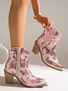 Moncelia pink sequin western ankle boots, worn and held by model showing the heel, women's sizes 5.5 to 12