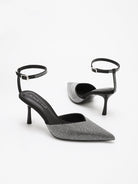 Moncelia black crystal paved pointed toe mules, pair shown from the side, women's sizes 5 to 11.5