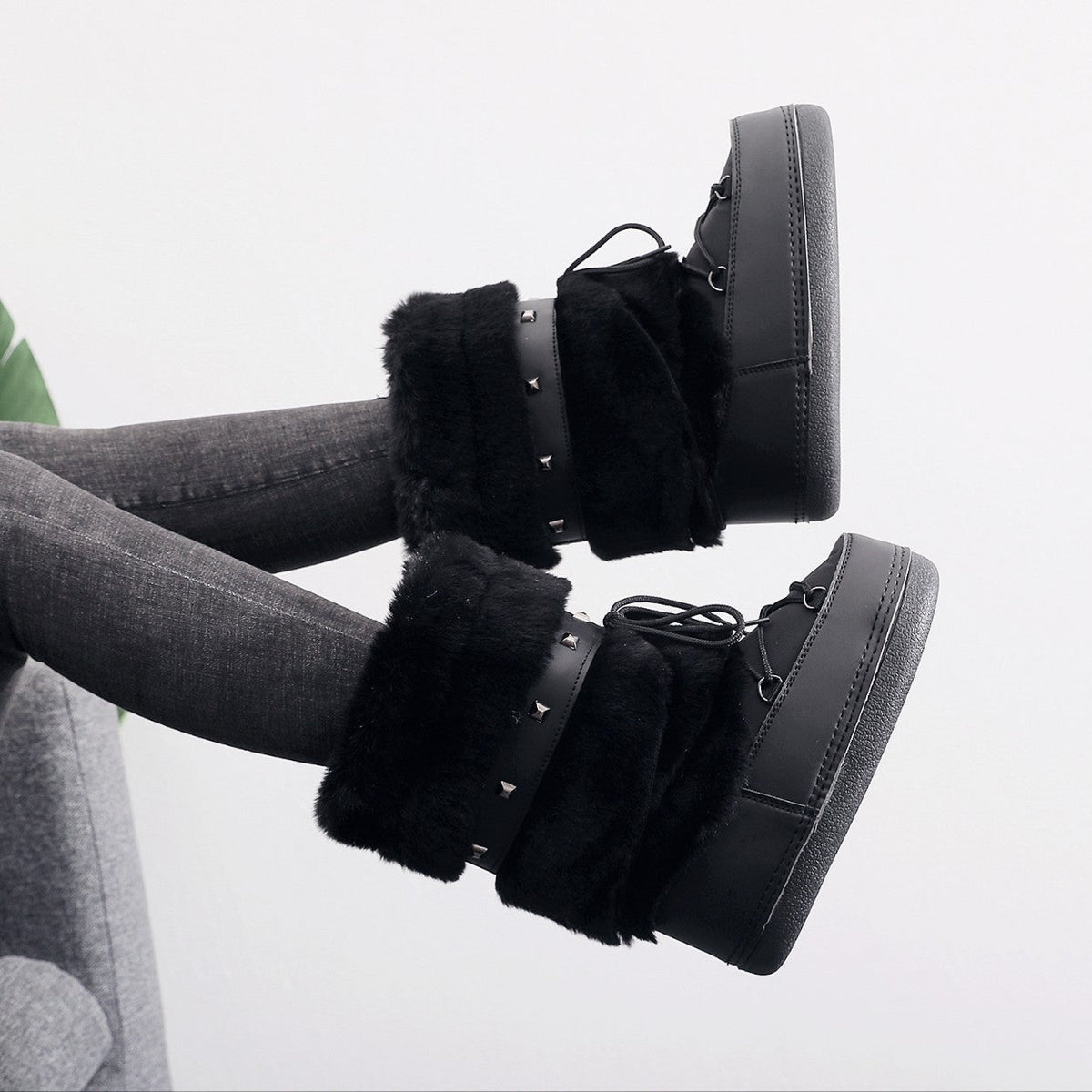 Moncelia black faux fur studded platform snow boots, worn on model with legs raised, women's sizes 5.5 to 9