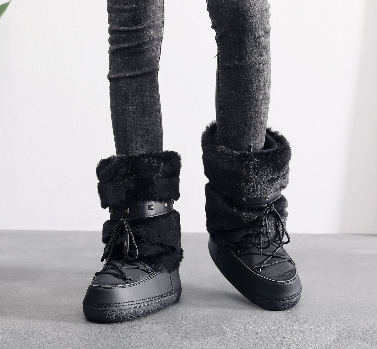 Moncelia black faux fur studded platform snow boots, front view on model with jeans, women's sizes 5.5 to 9