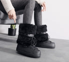 Moncelia black faux fur studded platform snow boots, worn seated with grey jeans, women's sizes 5.5 to 9